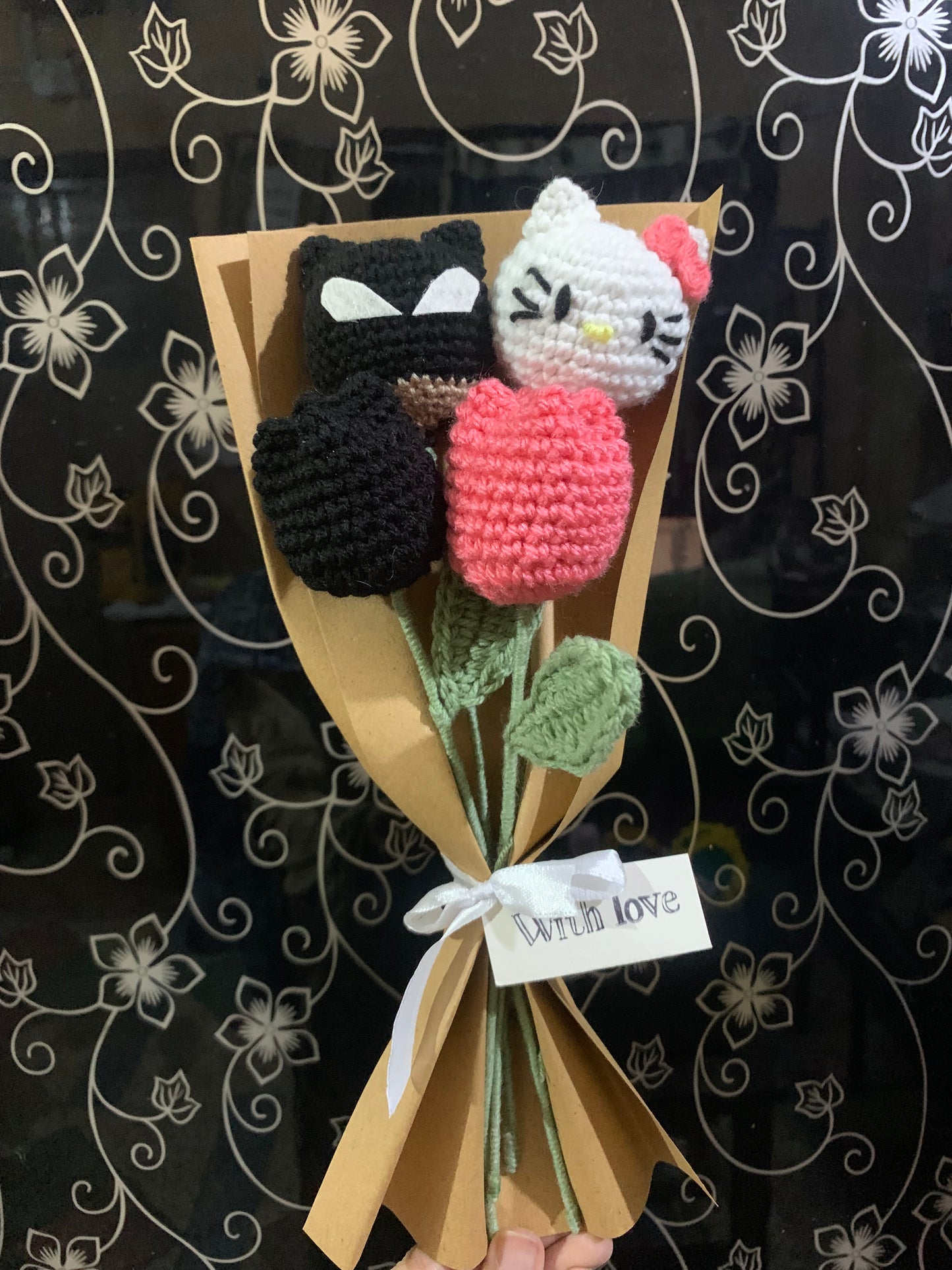 Crochet batman hello kitty themed flowers with complementary khaaki wrapping