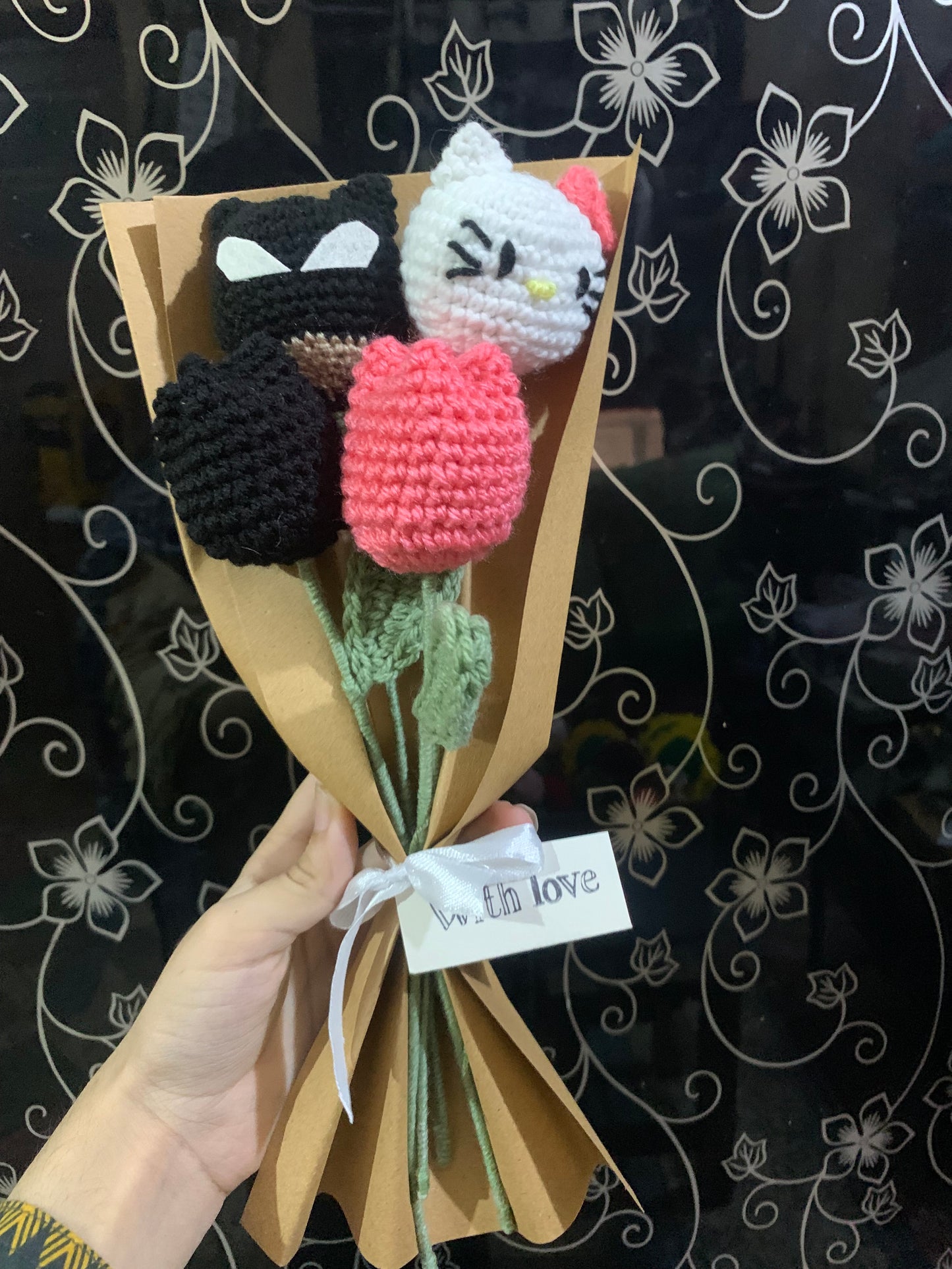 Crochet batman hello kitty themed flowers with complementary khaaki wrapping