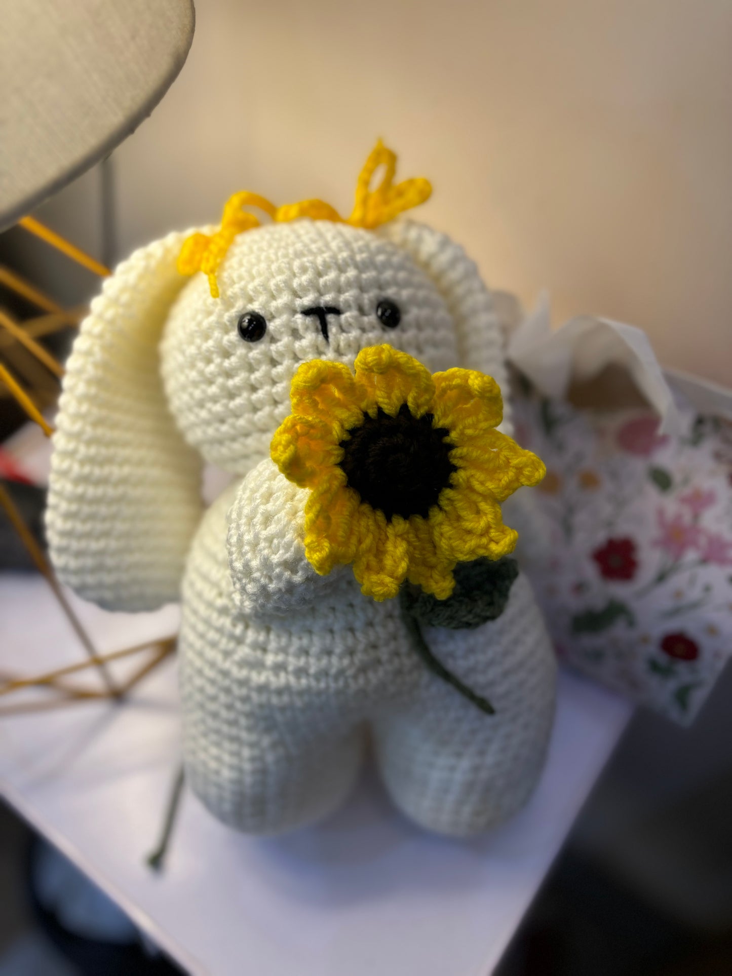 Crochet bunny holding sunflower