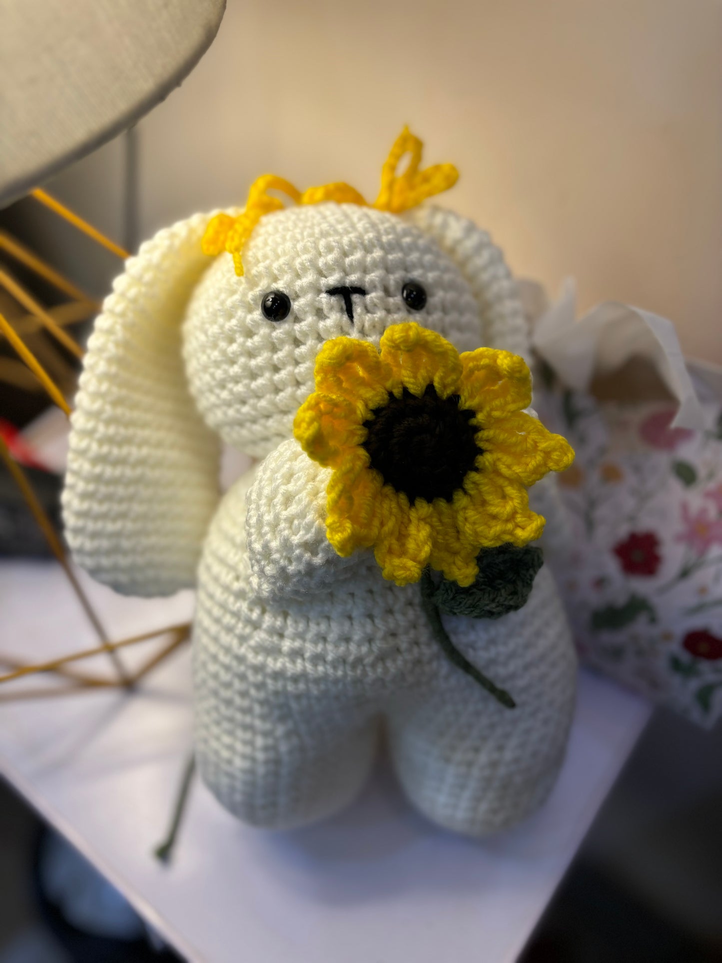 Crochet bunny holding sunflower