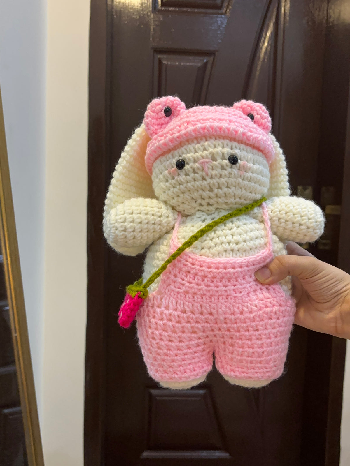 Bunny with pink romper, cap and a strawberry bag