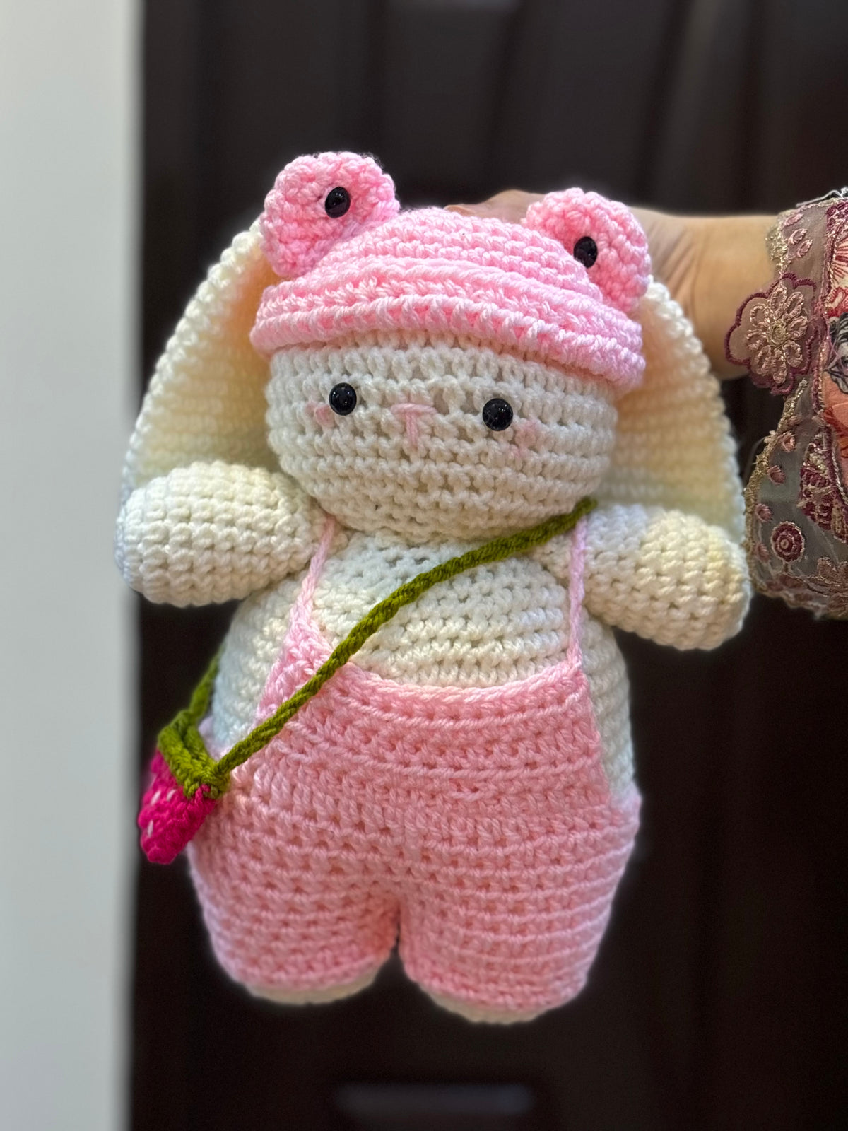 Bunny with pink romper, cap and a strawberry bag